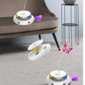 White spinning interactive cat toys with feather teasers and coloured balls, shown in a living room setting
